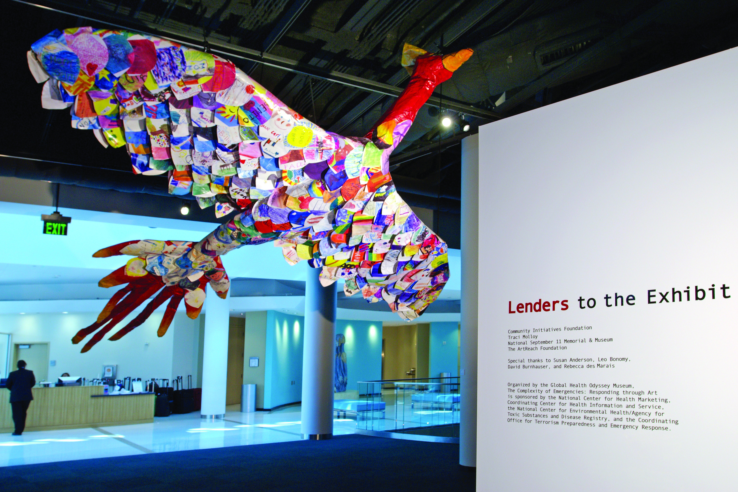 A photo of the CDC museum, with a bird sculpture made of pieces of paper with drawings and notes on them.